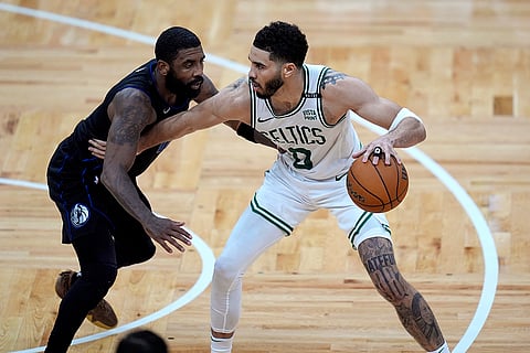 Jayson Tatum fends off Dallas Mavericks guard Kyrie Irving